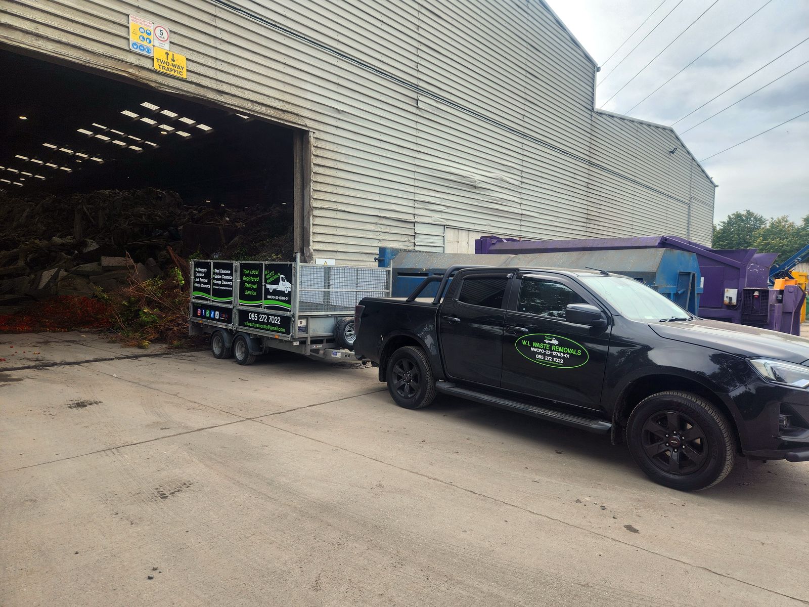 W.L Waste Removals pickup and trailer at a recycling facility